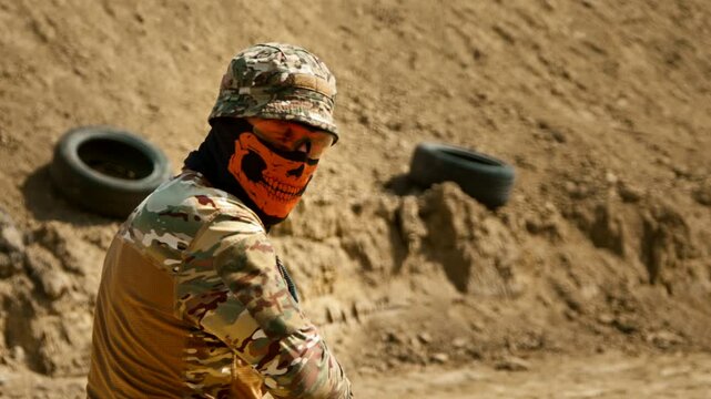 Man in tactical gear listens to instructor during shooting practice, lowers rifle, and then refocuses on target. Close-up cinematography captures intense training moment at the shooting range.