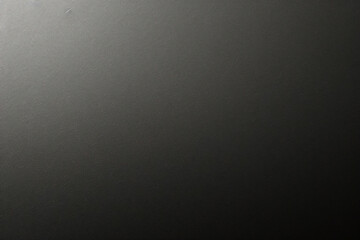 マットグレーの滑らかなプラスチックの表面に細かい質感があり、右側にビネットが付いています。絶妙なテクスチャ背景、柔らかい空白の背景	