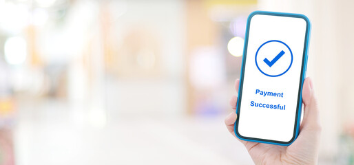 Hand holding smart phone with payment successful on screen, online banking, shopping online, cashless transaction