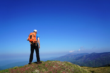 Mountaineer trekking on the beautiful mountain with camera making photo.