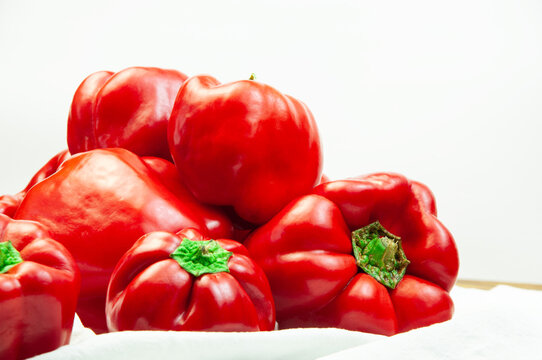 red bell pepper on a white towel on the table. Bulgarian juicy pepper on a light texture