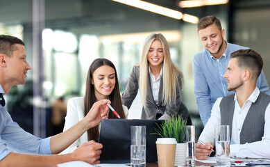 Group of business partners discussing ideas and planning work in office.