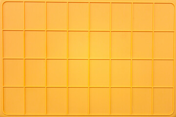 yellow plastic tile background, closeup of photo, elevated top view