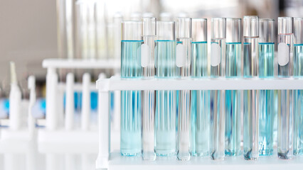 Close up Pipette dropping a sample into a test tube for research tool anatomy of small organisms with metal lens at laboratory, Biology science and medical concept.