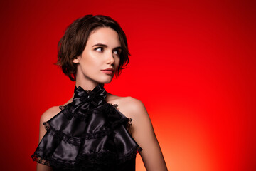 Fototapeta premium Portrait of gorgeous woman model hollywood star promoting store over dark red background
