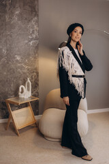 a stylish young woman in a black suit