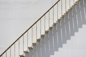 A staircase with a white railing and white steps