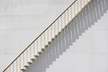 A white staircase with a shadow cast on the wall