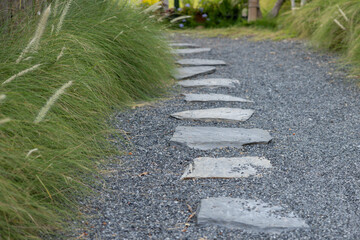 A path with a stone walkway and grassy area