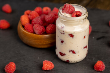 delicious and fresh yogurt with raspberry flavor and whole red raspberries