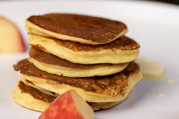 milk pancakes with butter and sliced peach slices