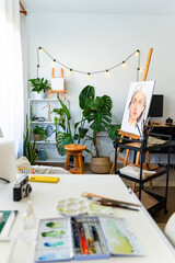 Artist painting in her organized workspace