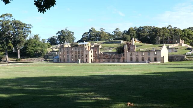 Remains of the main buildings for convicts of a famous Tasmanian prison. Historic buildings and museums in Tasmania. Port Arthur Heritage Prison Site. Park and ancient buildings on a sunny day. 