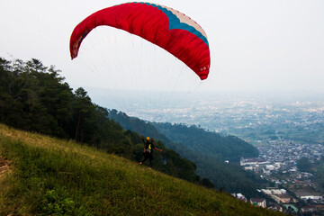 Some people are paragliding on a mountain with beautiful views