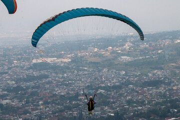 Some people are paragliding on a mountain with beautiful views