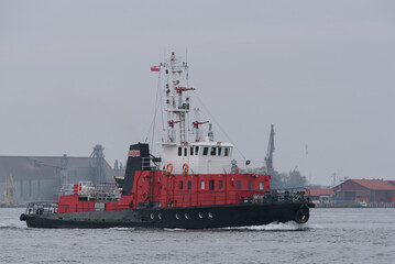 Fototapeta premium FIREBOAT - A red ship sails on the sea