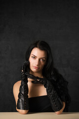 Beautiful dark-haired woman in black long gloves