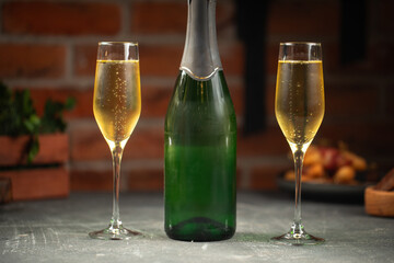 Green bottle of champagne and two glasses