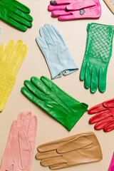 Bright, multi-colored gloves on a beige background