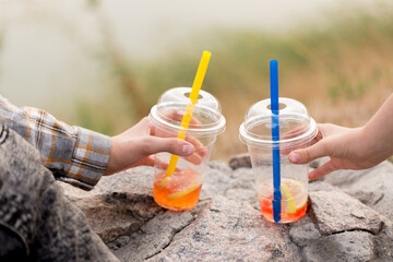 Two drink bubble tea in children's hands, close-up