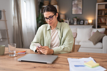 Young freelance business woman financial and economy expert waiting and preparing for video call conversation. Business person working from home on laptop computer taking a break.