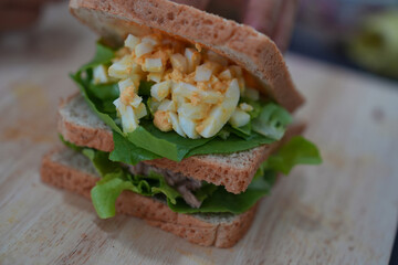 Making tuna and eggs sandwich.