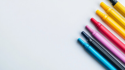 Brightly colored markers displayed on a plain white surface, seen from above. These art tools ignite creativity and passion.