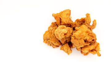 Crispy, golden-brown pieces of fried chicken, popcorn chicken or a similar bite-sized preparation, isolated on a white surface. A popular and convenient snack.