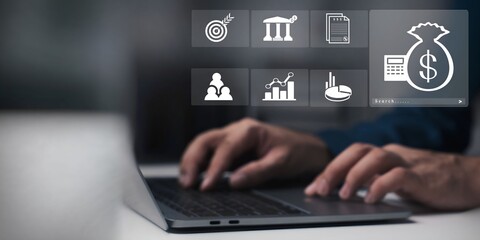 A businessman using laptop with visual budget and financial planning concept. 