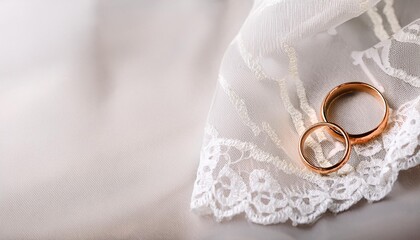 Elegant Vows: Wedding Rings on White Lace Scarf Backdrop
