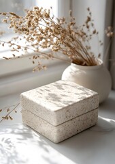 Beige Square Box With Dried Flowers In A Vase On A White Marble Surface