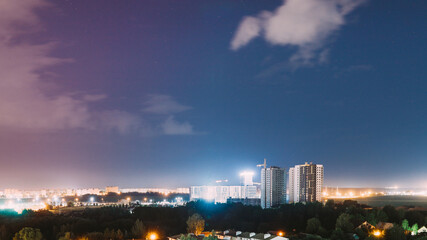 Fototapeta premium night works with construction site area. Development Multistorey Residential Building in night hours. development on construction site. night time work. Construction And Development Of Modern Multi