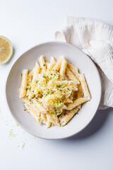 Creamy lemon pasta with hot pepper in white bowl.
