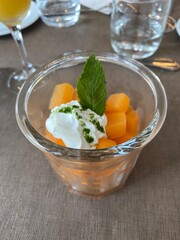sliced ​​melon and its crème fraîche with herbs