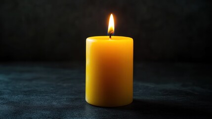 yellow candle with dark background for memorials, funerals, and obituaries concept
