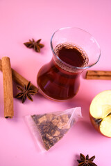 Turkish tea in a traditional cup with cinnamon and apple. Spiced tea