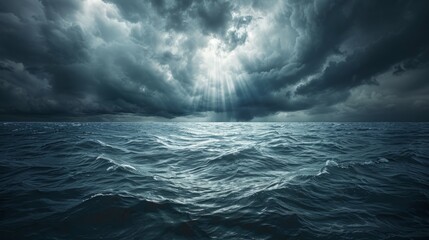 Dramatic coastal seascape with dark clouds and rays of light over turbulent waters