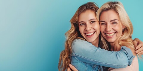 Two women are hugging each other and smiling. Scene is happy and warm. The women are likely friends or family members, and the hug conveys a sense of love and affection