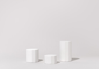 Cosmetics product presentation background scene made with three white pillars podium stage in sunlight. Ideal for showcasing cosmetics, perfumery, jewelry and branding visuals. Studio photography.