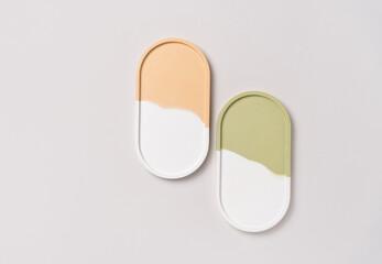 Beauty cosmetic product presentation background made with two mockup oval trays on white surface. Studio photography.