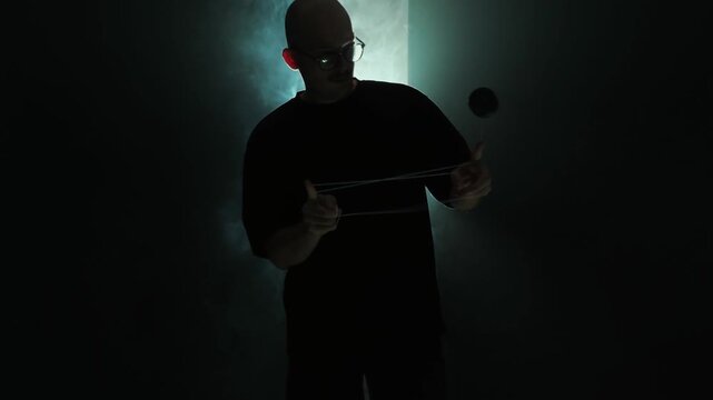 guy professionally spins yo yo, rope tricks, great background, light through fog