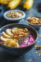Fototapeta premium Acai bowl with fruits, sliced banana, yogurt and crunchy granola. Macro view.