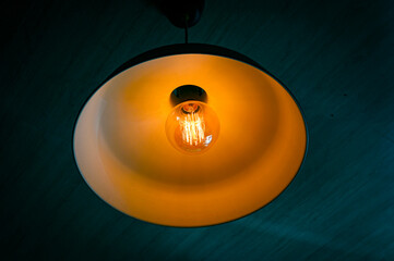 Close-up of glowing bulb lampshade with yellow light