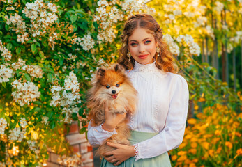 Happy young woman hands holding Pomeranian dog red fur in hands. Joyful girl smiling beautiful face, adoration fun animal small fluffy pet with love care. Summer nature green tree city park walk