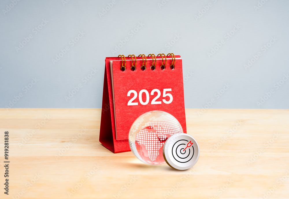 Wall mural Happy new year 2025 with global business, digital marketing, goal and technology concept. 3d Target icon with red 2025 calendar near glass earth globe on wood table and grey background, minimal style.