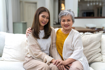 Obraz premium Portrait of enjoy happy love asian family senior mature mother and young daughter smiling play laughing and having fun together at home, care, elderly, insurance.happy family and Mother Day concept