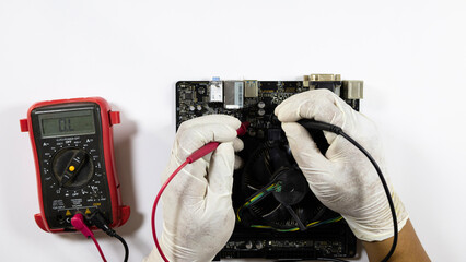 Technician use old circuit board measuring tools to inspect and repair them so they can be used again. Close up hands of technician Checking old circuit board.