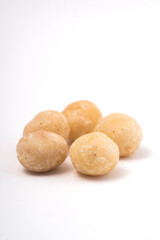 Macadamia nuts on white background. Selective focus with shallow depth of field.