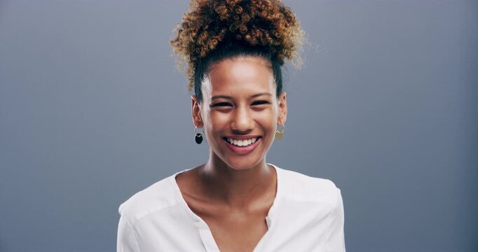 Funny, black woman and laugh in studio with face of happiness, freedom or reaction to joke. Happy, portrait and girl with comedy, comic or lol emoji with humor and smile in grey background or mockup