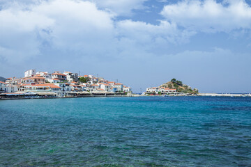 Seascape. Houses with tiled roofs between the sea and the sky. Samos Island, Pythagorio, Greece.